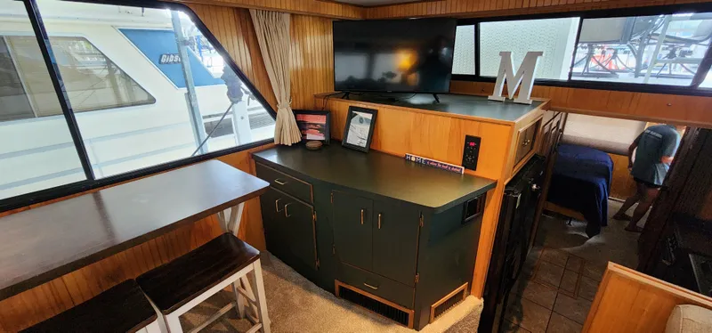 Slide: The Image of Interior of a 1993 Gibson 50 Cabin Yacht with modern amenities and wood paneling. - 41