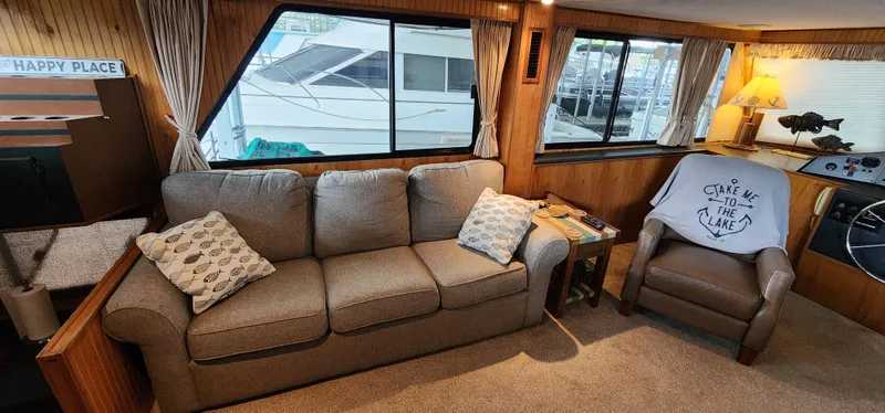 Slide: The Image of Interior of a 1993 Gibson 50 Cabin Yacht with cozy seating area and large windows. - 44