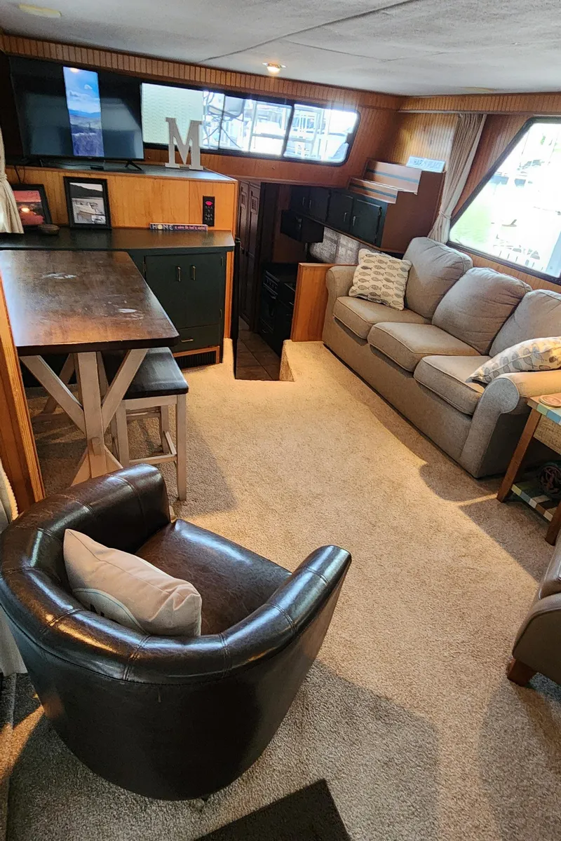 Slide: The Image of 1993 Gibson 50 Cabin Yacht interior with cozy seating and dining area. - 45