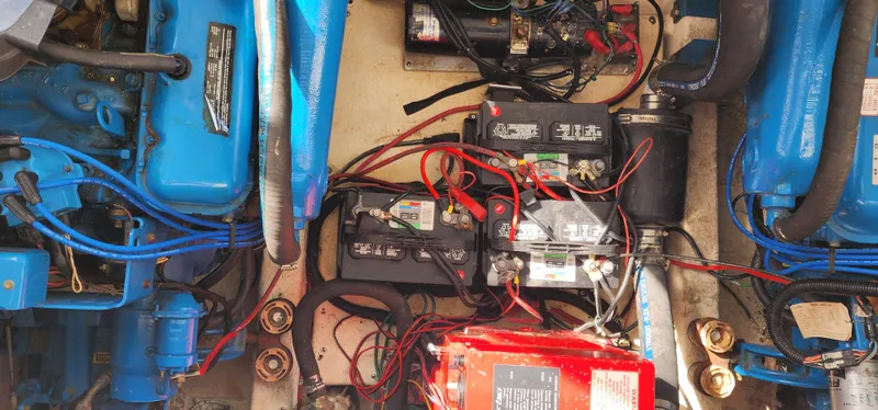 Slide: The Image of Engine compartment of a 1993 Gibson 50 Cabin Yacht with visible batteries and wiring. - 9