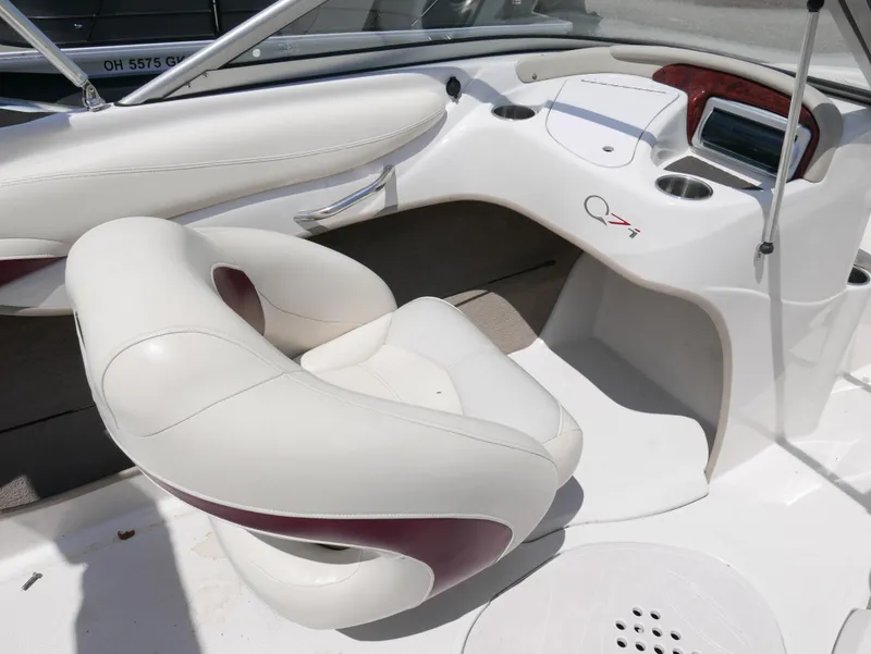 Slide: The Image of 2011 Tahoe Q7SSF1 boat interior with white and maroon seating and dashboard. - 11
