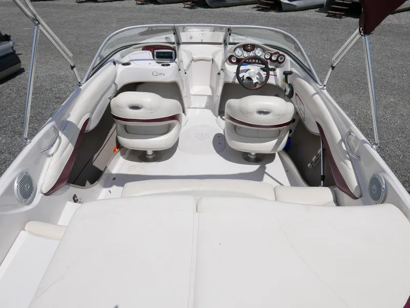 Slide: The Image of 2011 Tahoe Q7SSF1 boat interior with white and maroon seating, steering console, and dashboard. - 12