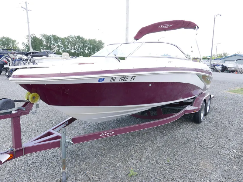 Slide: The Image of 2011 Tahoe Q7SSF1 boat on trailer with maroon and white exterior. - 2