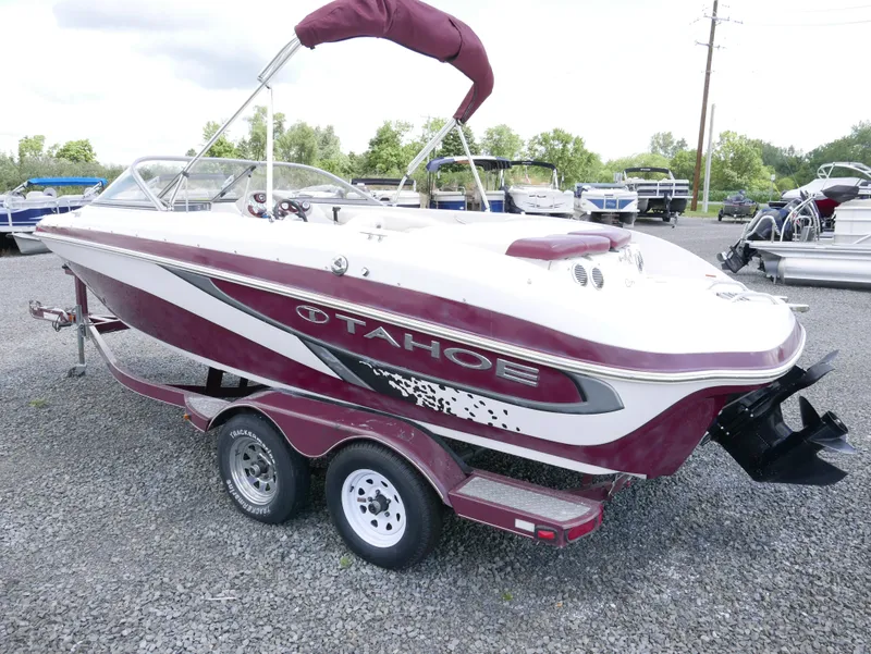 Slide: The Image of 2011 Tahoe Q7SSF1 boat on a trailer in a parking lot. - 3