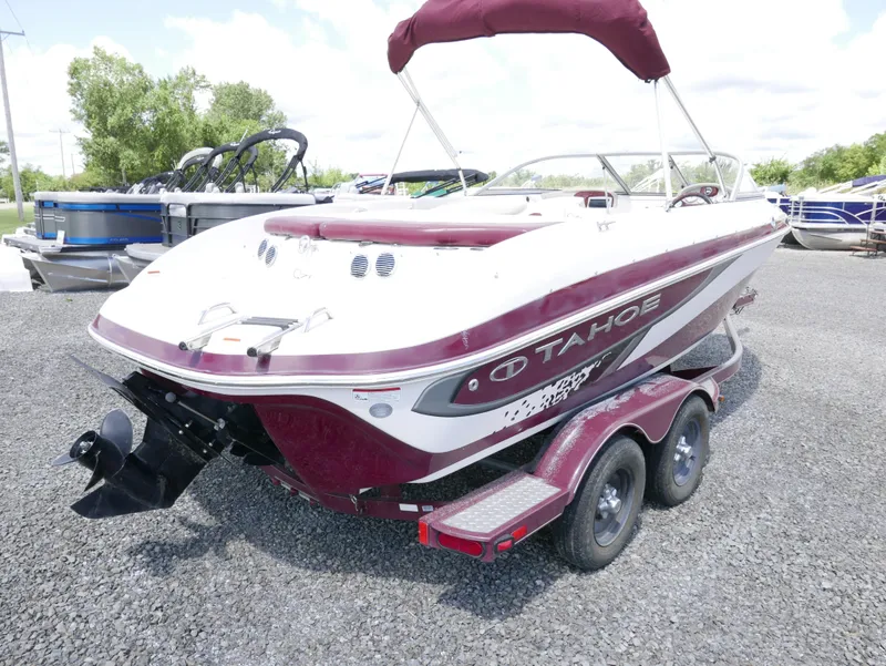 Slide: The Image of 2011 Tahoe Q7SSF1 boat on a trailer in a parking lot. - 4