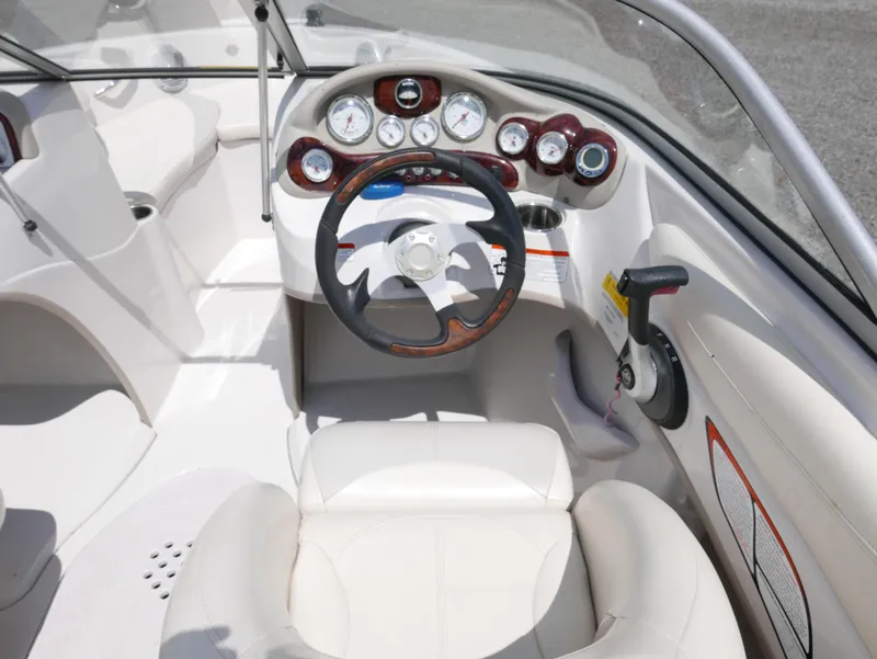 Slide: The Image of Steering console of a 2011 Tahoe Q7SSF1 boat with white and wood accents. - 9