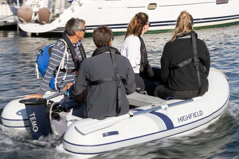 Slide: The Image of Four people in a Highfield Roll-Up 200 KAL inflatable boat on water. - 4