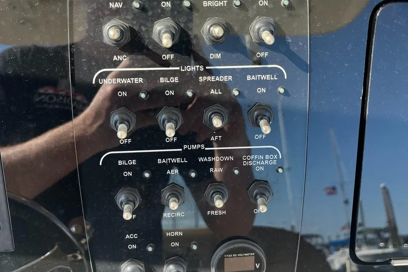Slide: The Image of Control panel of a 2019 Scout 235 XSF boat with various switches. - 10