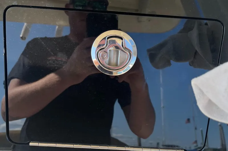 Slide: The Image of Close-up of a 2019 Scout 235 XSF boat's chrome latch. - 11