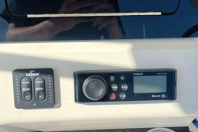 Slide: The Image of Control panel of a 2019 Scout 235 XSF boat with Lenco and Fusion systems. - 12