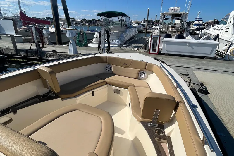 Slide: The Image of 2019 Scout 235 XSF boat interior at a marina with other boats. - 15