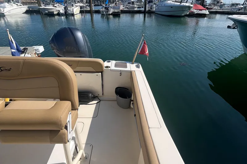 Slide: The Image of 2019 Scout 235 XSF boat docked at marina with other boats in background. - 18