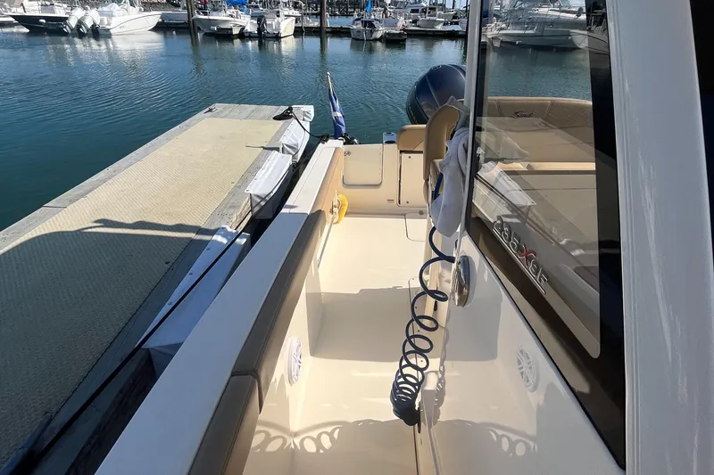 Slide: The Image of 2019 Scout 235 XSF boat docked at a marina. - 19