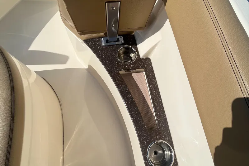 Slide: The Image of 2019 Scout 235 XSF boat interior with cup holders and beige seating. - 20
