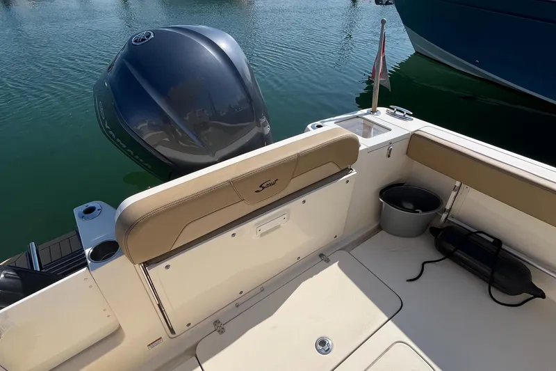 Slide: The Image of 2019 Scout 235 XSF boat interior with outboard motor in water. - 21