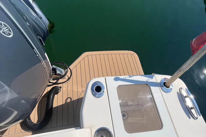 Slide: The Image of 2019 Scout 235 XSF boat stern with outboard motor and teak deck. - 24