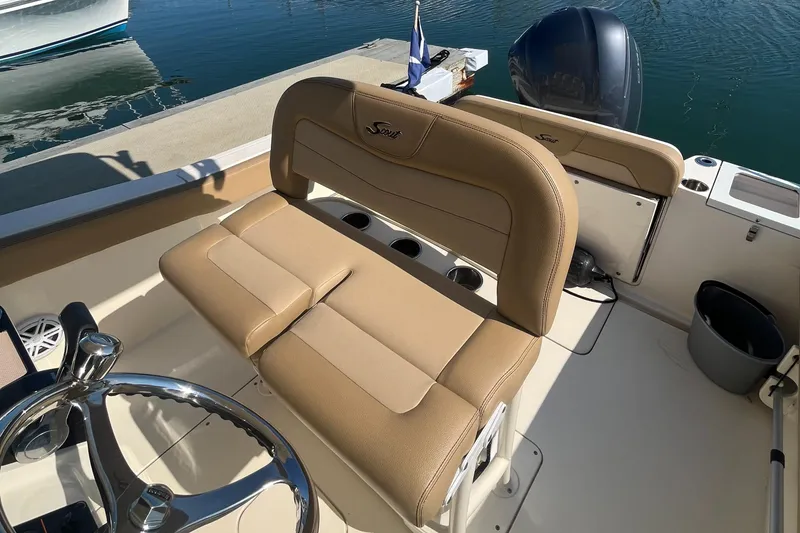 Slide: The Image of 2019 Scout 235 XSF boat interior with tan seating and steering wheel. - 6