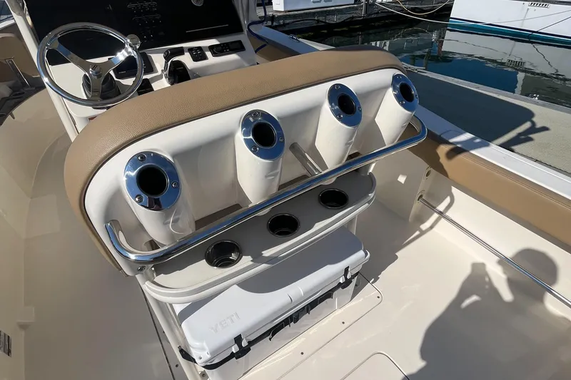 Slide: The Image of 2019 Scout 235 XSF boat interior with rod holders and steering wheel. - 8