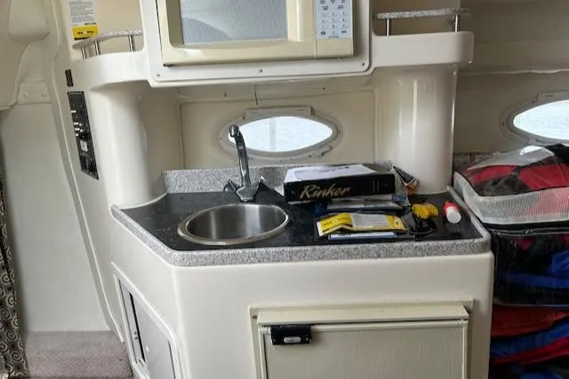 Slide: The Image of 2001 Rinker 270 Fiesta Vee boat interior with kitchenette and sink. - 8