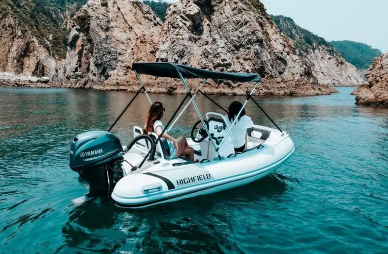 The Image of 2024 Highfield Sport 330 boat cruising in scenic rocky waters. - 0