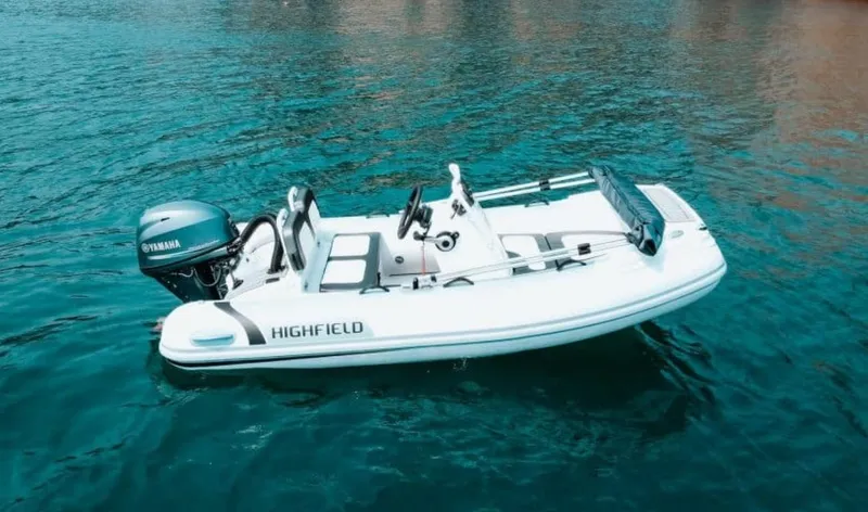 Slide: The Image of 2024 Highfield Sport 330 inflatable boat on clear blue water. - 1