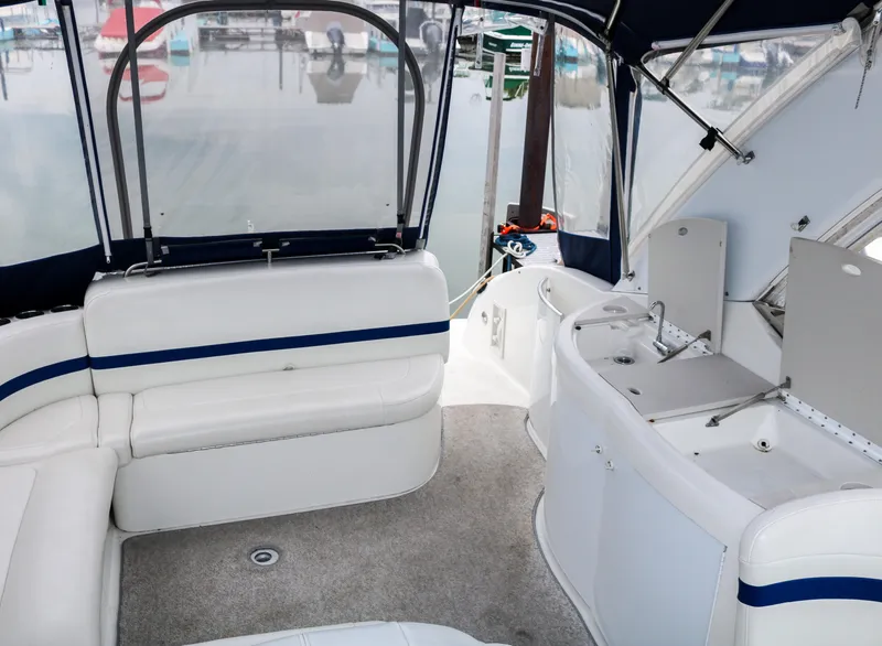 Slide: The Image of Interior of a 2003 Formula 370 Super Sport boat with white seating and covered deck. - 13