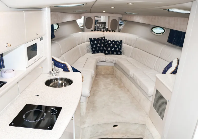 Slide: The Image of Luxurious interior of a 2003 Formula 370 Super Sport yacht with white leather seating. - 14