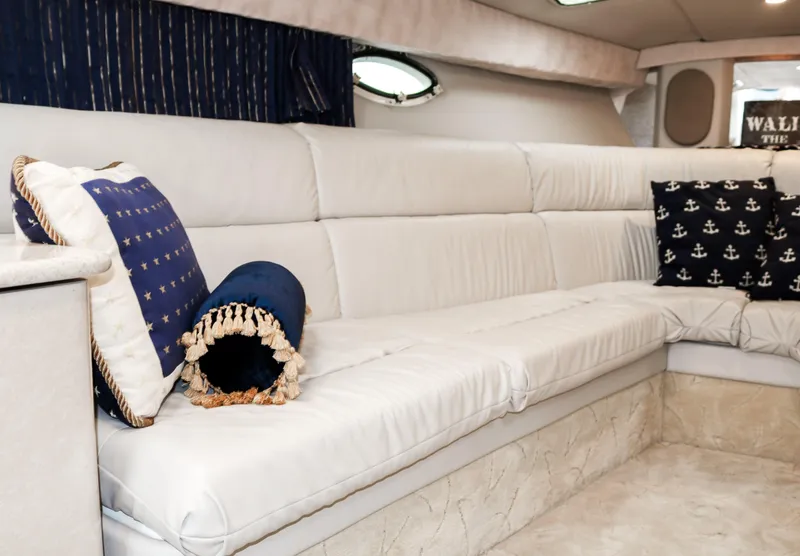 Slide: The Image of Interior of 2003 Formula 370 Super Sport boat with white leather seating and nautical-themed pillows. - 18