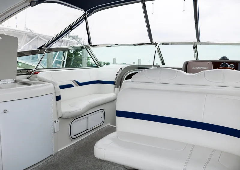 Slide: The Image of Interior of a 2003 Formula 370 Super Sport boat with white and blue seating. - 6