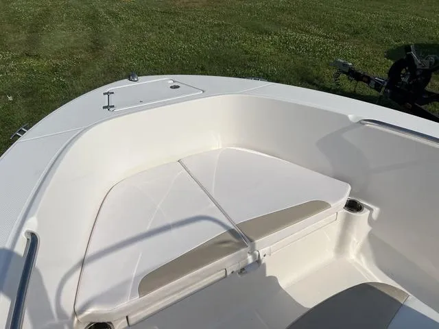 Slide: The Image of 2019 Robalo R180 boat interior with white seating and storage compartment. - 11