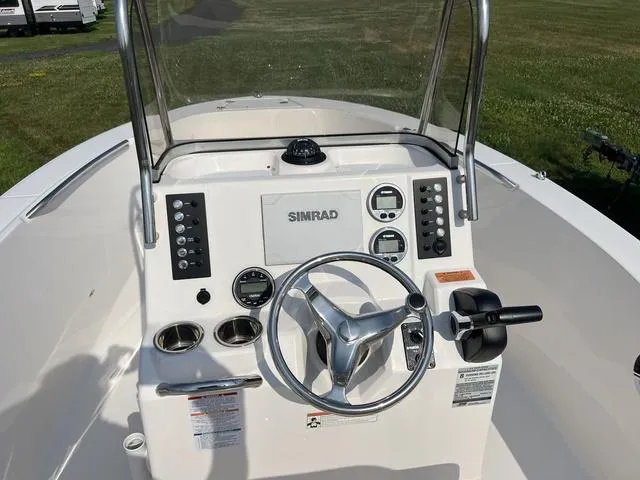 Slide: The Image of 2019 Robalo R180 boat console with Simrad display and steering wheel. - 12