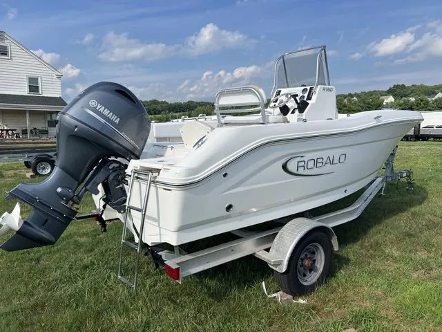 Slide: The Image of 2019 Robalo R180 boat with Yamaha engine on trailer, parked on grass. - 3