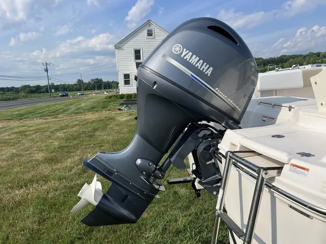Slide: The Image of 2019 Robalo R180 boat with Yamaha outboard motor on grassy area. - 4