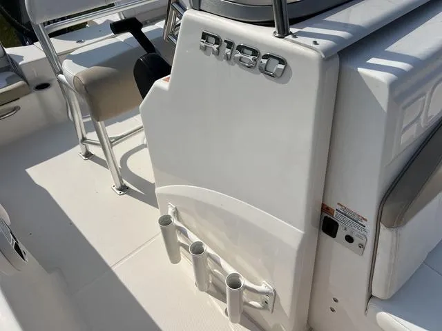 Slide: The Image of 2019 Robalo R180 boat interior with rod holders and seating. - 9
