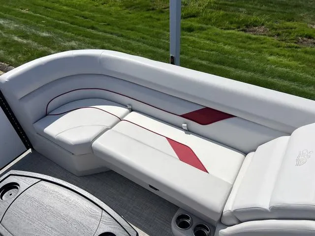 Slide: The Image of 2024 SunCatcher Select 22SS boat interior with white and red seating. - 15