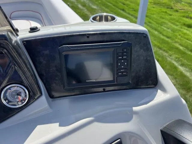 Slide: The Image of 2024 SunCatcher Select 22SS boat dashboard with Garmin display and cup holder. - 20