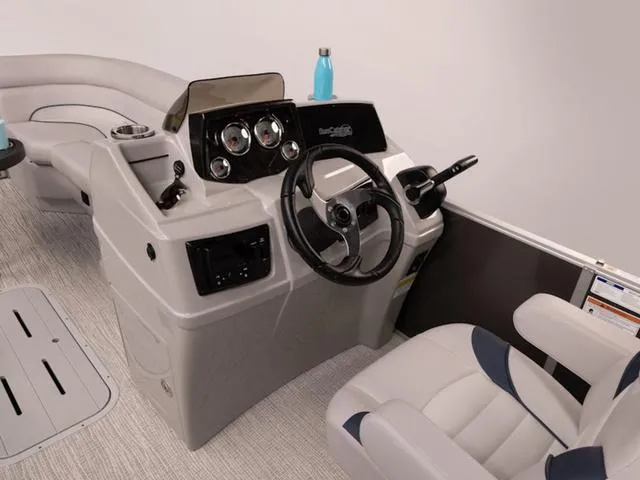 Slide: The Image of 2024 SunCatcher Select 22SS boat interior with steering console and seating. - 21