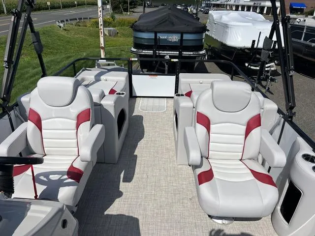 Slide: The Image of 2024 SunCatcher Select 22SS boat with open storage compartment and beige seating. - 7