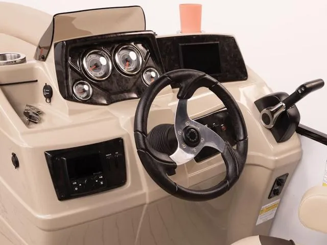 Slide: The Image of 2024 SunCatcher Select 18C boat dashboard with steering wheel and control panel. - 20