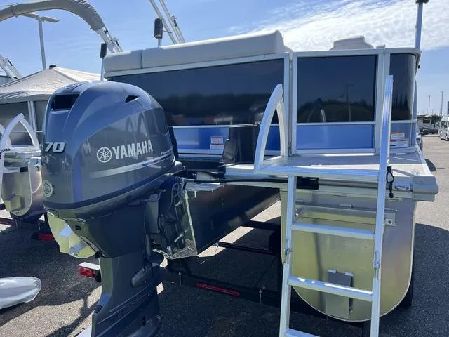 Slide: The Image of 2024 SunCatcher Select 18C pontoon boat with motor and boarding ladder. - 5