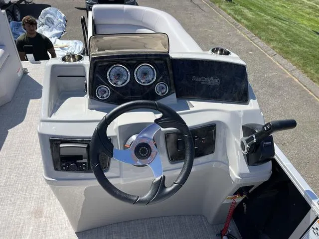 Slide: The Image of 2024 SunCatcher Select 18C pontoon boat with open storage compartment and seating area. - 7