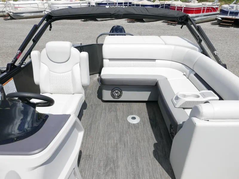 Slide: The Image of 2023 Godfrey SWEETWATER 2086 boat interior with white seating and steering console. - 6