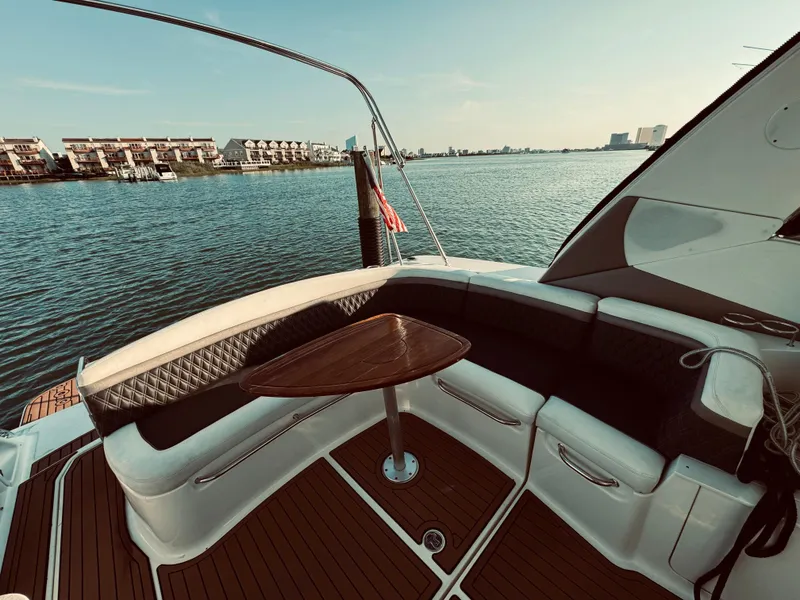 Slide: The Image of 2008 Sea Ray 350 Sundancer boat with a view of the water and cityscape. - 10