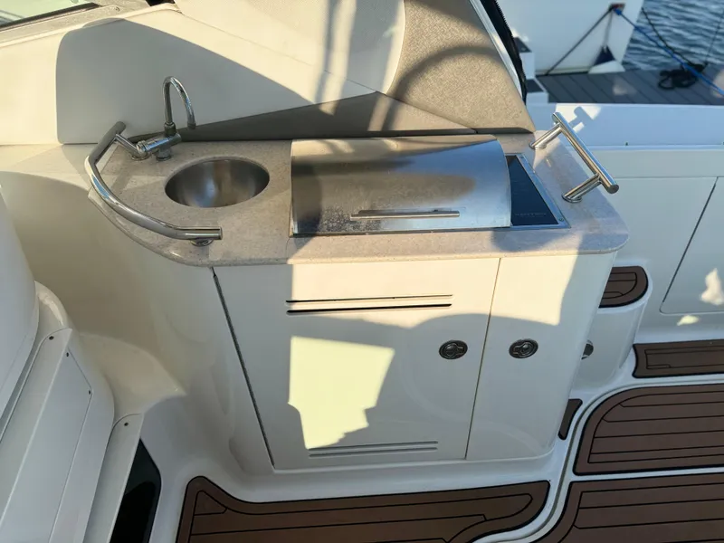 Slide: The Image of 2008 Sea Ray 350 Sundancer boat kitchenette with sink and grill. - 13