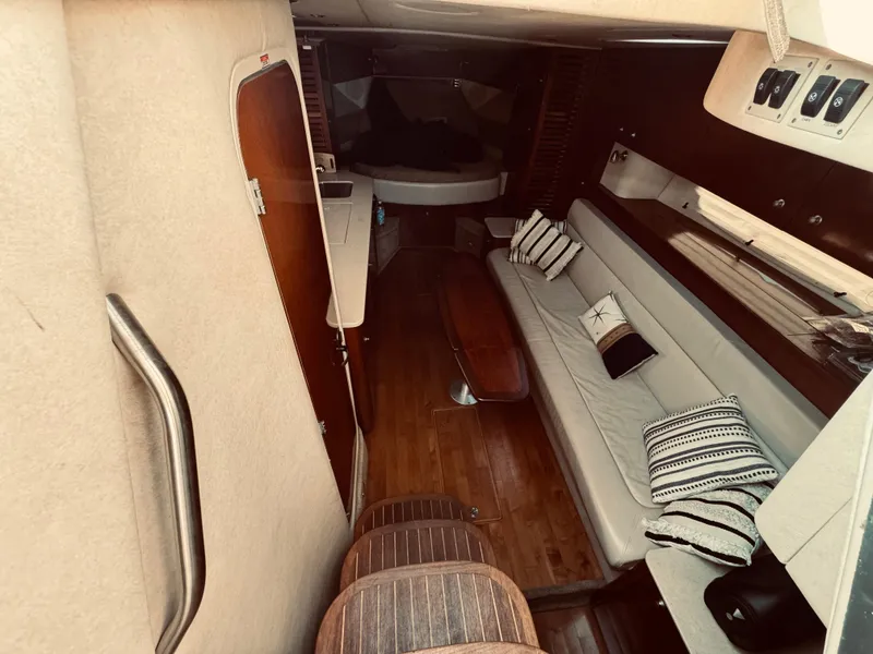 Slide: The Image of 2008 Sea Ray 350 Sundancer cabin interior with seating and wooden flooring. - 19