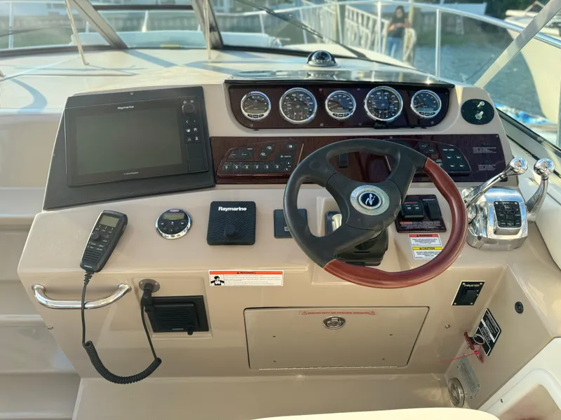 Slide: The Image of 2008 Sea Ray 350 Sundancer helm with navigation equipment and controls. - 4