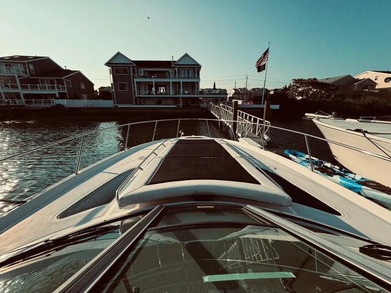 Slide: The Image of 2008 Sea Ray 350 Sundancer docked near waterfront homes. - 6