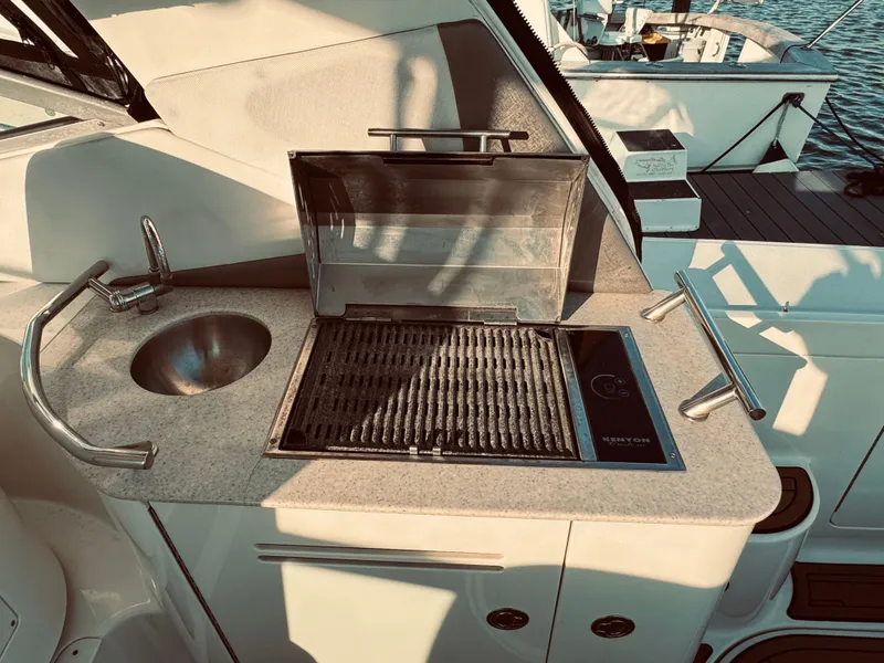 Slide: The Image of Outdoor kitchen on a 2008 Sea Ray 350 Sundancer yacht with grill and sink. - 8