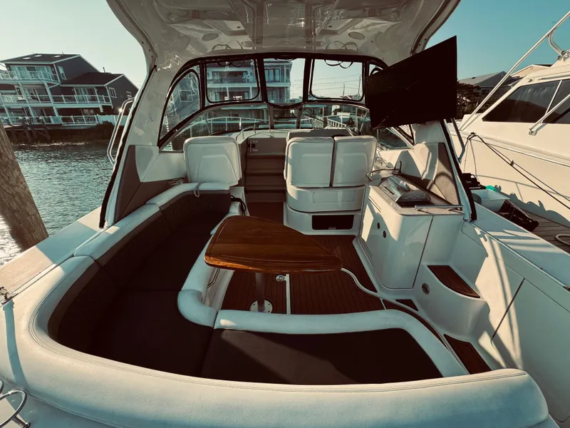 Slide: The Image of 2008 Sea Ray 350 Sundancer boat interior with seating and TV. - 9