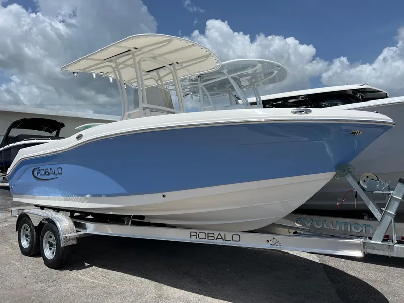 The Image of 2025 Robalo R200 Center Console boat on a trailer under a cloudy sky. - 0